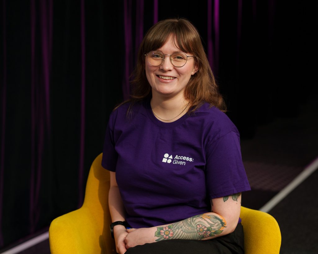 Ellen is a white woman with light brown hair and glasses